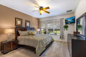 a bedroom with a bed and a ceiling fan at Olivia's Dream Villa on WindsorHills in Orlando +33 photos