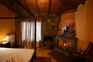 a bedroom with a fireplace and a bed in a room at Ta Petrina in Ano Chora