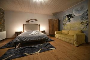 a bedroom with a bed and a couch at Ta Petrina in Ano Chora