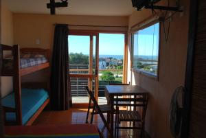 a bedroom with a bunk bed and a table and chairs at Terrazas de Aguas Dulces in Aguas Dulces
