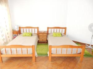 two twin beds in a room with at Apartamentos Turísticos Pérola da Rocha II in Portimão