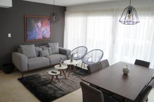 a living room with a couch and a table at Metropolitan Suites in Guadalajara