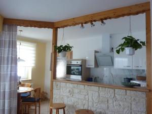 a kitchen with white cabinets and a table and chairs at Ferienwohnung Edelmann in Markersbach