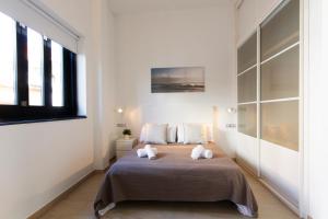 Un dormitorio con una cama grande con dos almohadas. en Valentia Apartments - Mercado Central, en Valencia