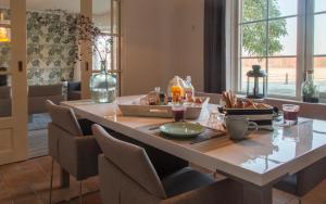a dining room with a table with food on it at B&B en vakantie appartement de Glinthaar in Lemele +18 photos
