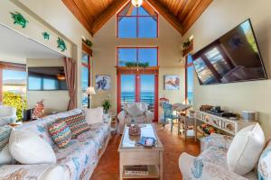 a living room with a couch and a tv at Art on the Beach in Stuart