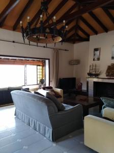 a living room with a couch and a fireplace at Villa con piscina privada in Torremolinos