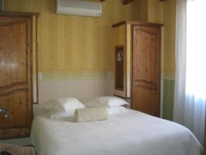 a bedroom with a bed with a towel on it at La Marjolaine in Juan-les-Pins