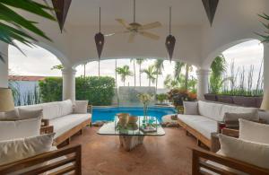 a living room with white furniture and a pool at Mi Otra Casa in Sayulita