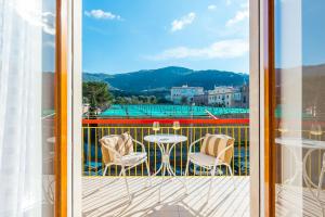 a balcony with a table and chairs and a view at Aranci 99 House in Sorrento