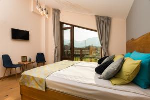 a bedroom with a large bed with a large window at Luxury Chalet & Spa Tia Maria in Bansko +46 photos