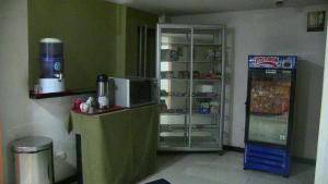 a kitchen with a refrigerator and a refridgerator at Hotel Mónaco de Fusa in Fusagasuga