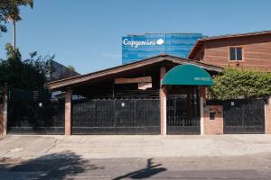 a building with a gate in front of a building at Dai Nonni Hotel in Guatemala