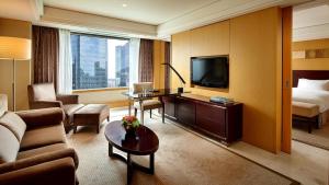 
a living room filled with furniture and a tv at Lotte Hotel Seoul in Seoul
