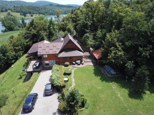 an aerial view of a house on a hill with cars parked at Villa Jelenic by Bertovic in Ogulin