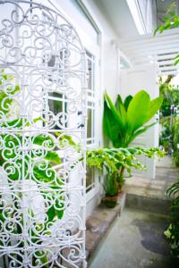 a white gate in a garden with plants at Charming La Casita Mercedes, 5Br and 5TB for Family and Friends Staycation- Read Listing Info in Manila