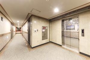 een lege hal met een deur in een gebouw bij Major Hotel in Jeju-stad