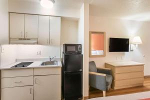 a kitchen with a black refrigerator and a sink at Motel 6-Dothan, AL in Dothan