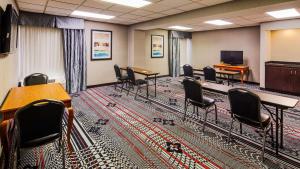 a conference room with tables and chairs and a tv at The Hotel at Dayton South in Dayton