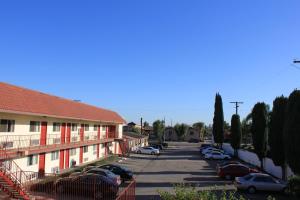 a parking lot with cars parked next to a building at Valley Hotel in Rosemead