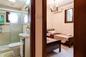 a bathroom with a bed and a sink and a toilet at Villa Elizabeth in Limassol +21 photos