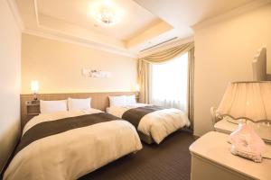 Ліжко або ліжка в номері Hotel Port Plaza Chiba