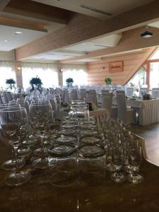 a long table with wine glasses on it at Pensjonat WOLSKI in Mizerna