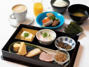 a table with a tray of different types of food at APA Hotel Kyoto Ekikita in Kyoto