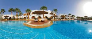 a large swimming pool in front of a resort at sharm suite privata Domina in Sharm El Sheikh