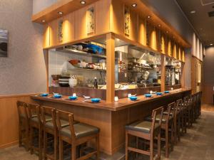 a bar with a row of chairs at a restaurant at APA Hotel Kyoto Ekikita in Kyoto +37 photos