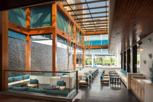 a lobby of a building with tables and chairs at Nap Patong in Patong Beach