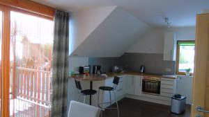 a kitchen with a table and chairs and a window at Ferienwohnung Csilla in Unterweid