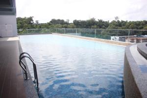 a swimming pool with a view of the water at Sunny Seaview@Icon Residence in Kuala Terengganu