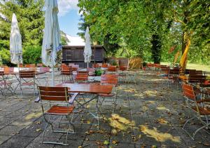 een groep tafels en stoelen met parasols bij Hotel Selau in Neunkirchen am Brand