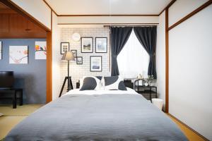 a bedroom with a large bed and a window at Naha Southerlies Condominium Kumoji in Makishimachi