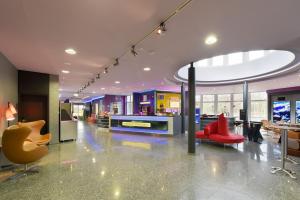 a lobby with chairs and tables in a building at Bed’nBudget Expo-Hostel Dorms in Hannover