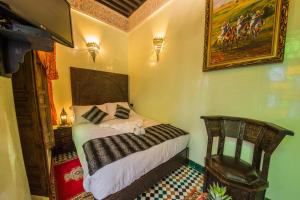 Postel nebo postele na pokoji v ubytování Riad Ghita Palace
