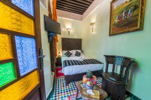 Postel nebo postele na pokoji v ubytování Riad Ghita Palace