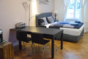 Un dormitorio con una cama y una mesa y sillas. en Kudamm Apartments, en Berlín