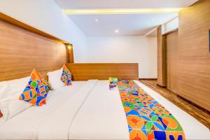 Ένα ή περισσότερα κρεβάτια σε δωμάτιο στο FabHotel Tranquil Heights Kodaikanal