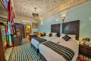 Postel nebo postele na pokoji v ubytování Riad Ghita Palace