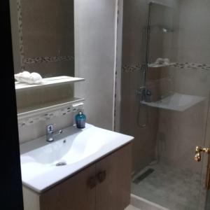 a bathroom with a sink and a shower at Luxury Flat Marina Agadir in Agadir