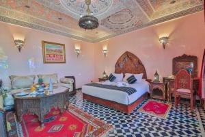 Postel nebo postele na pokoji v ubytování Riad Ghita Palace