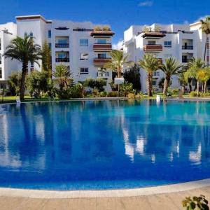 a large swimming pool in front of a building at Luxury Flat Marina Agadir in Agadir