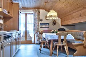 a kitchen with a table and a dining room with at Landhaus Carolin Göhl in Bad Hindelang