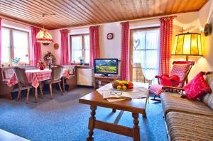 a living room with a couch and a table at Landhaus Carolin Göhl in Bad Hindelang