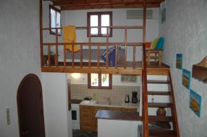 a room with a loft bed in a kitchen at Blue Vista Cottage Sitia in Sitia