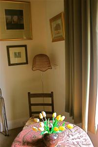 a table with a vase of flowers on top of it at Borough B&B in Eaglehawk