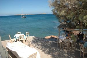 a group of people sitting at a table by the water at Blue Vista Cottage Sitia in Sitia +24 photos