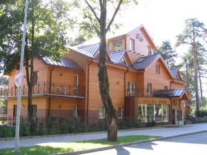 a large house with solar panels on the side of it at Hotel Vita in Druskininkai